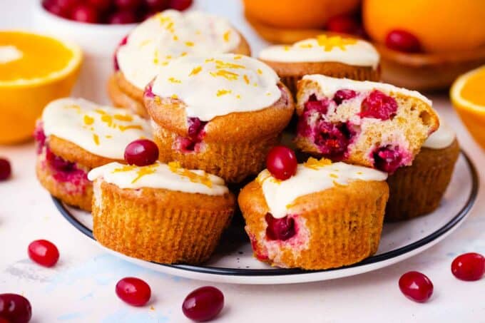 cranberry orange muffins topped with orange glaze