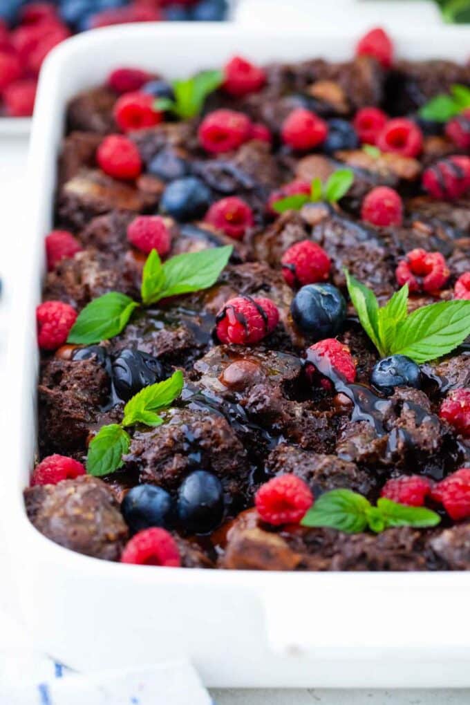 chocolate French toast casserole garnished with berries and mint leaves