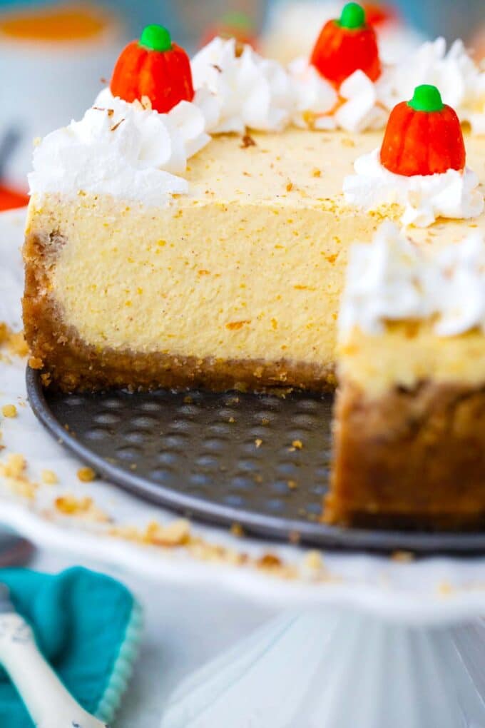 sliced instant pot pumpkin cheesecake on a cake stand