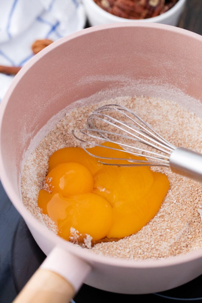 Whisking eggs into brown sugar and flour mixture.