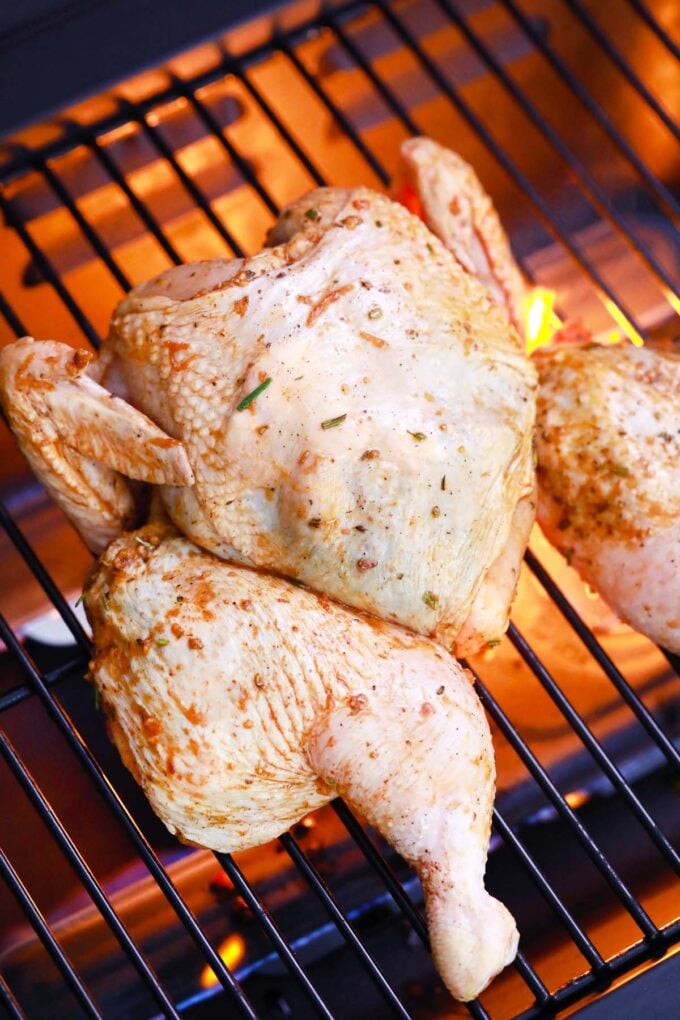 Fire grilling a whole chicken.
