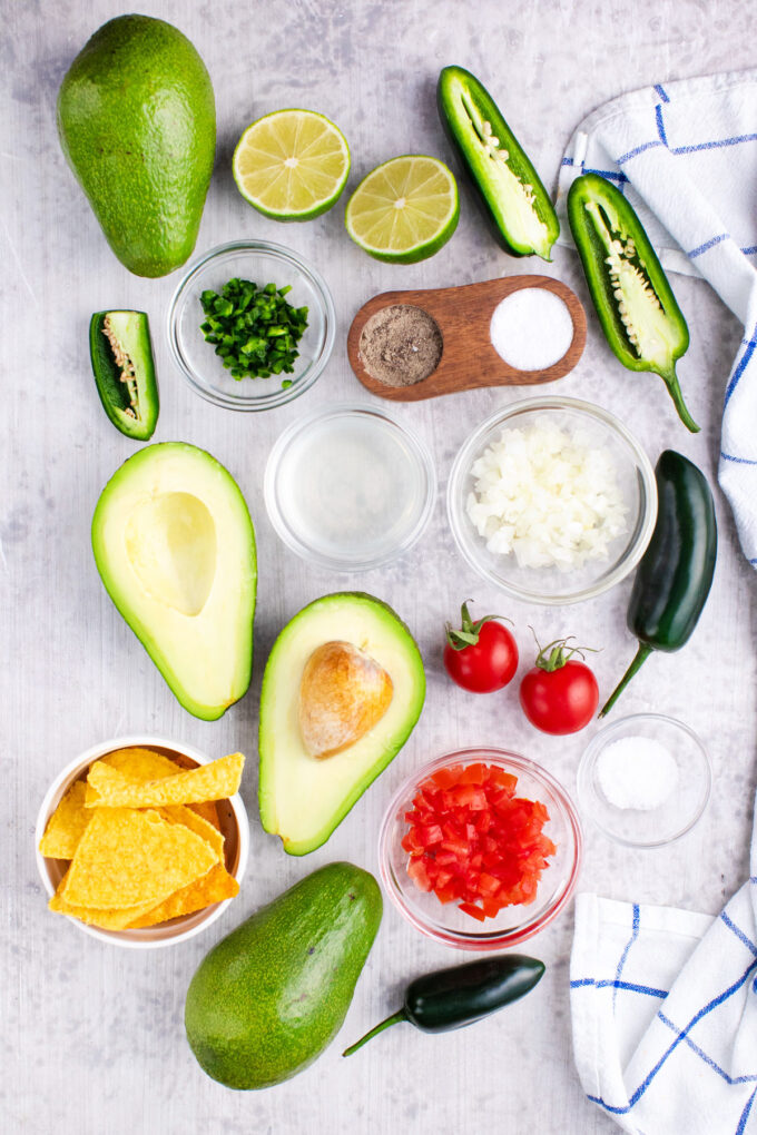 Overhead shot of guacamole recipe ingredients on a table.