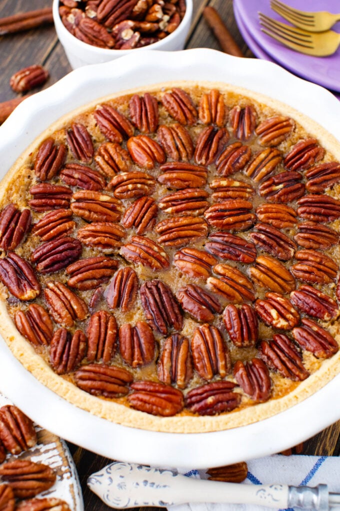Homemade pecan pie topped with pecans.