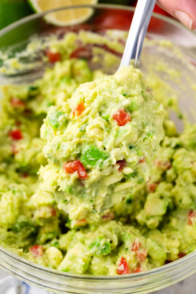 A spoonful of creamy and chunky guacamole.