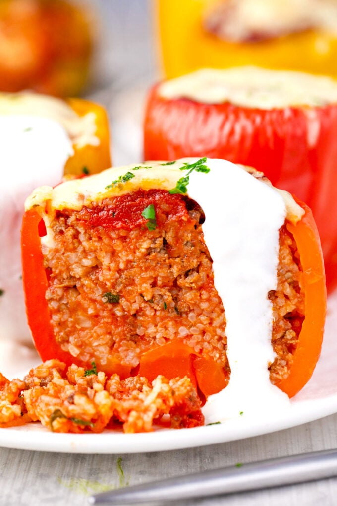 Homemade stuffed peppers sliced in half revealing beef and rice mixture.