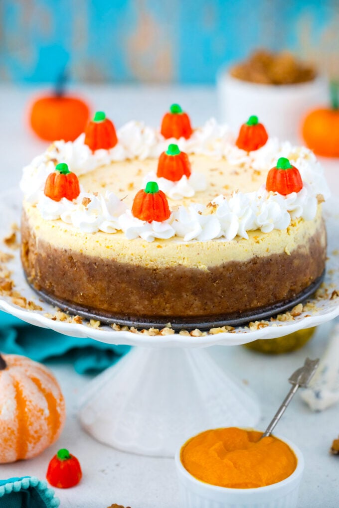 Instant Pot pumpkin cheesecake on a cake stand.