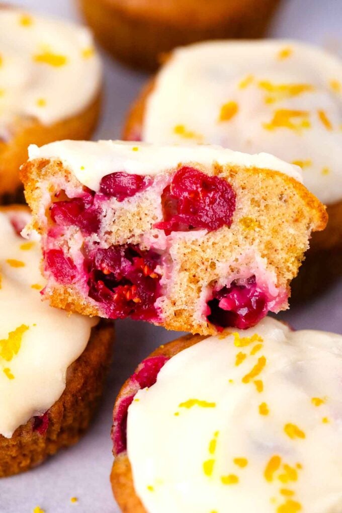 cranberry orange muffin sliced in half revealing juicy cranberries