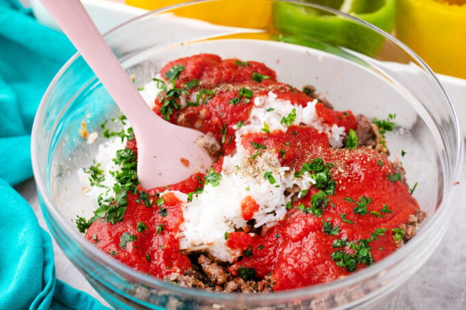 Mixing stuffed peppers filling.