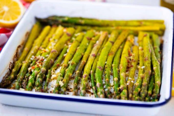 A baking pan with oven roasted asparagus.