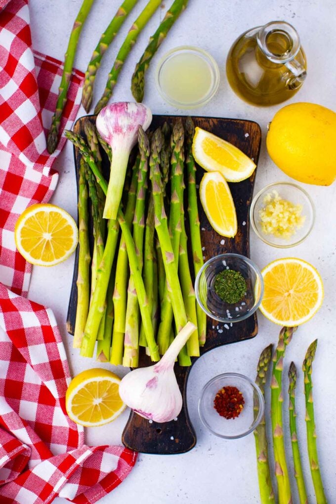 Overhead shot of oven roasted asparagus ingredients on a cutting board.