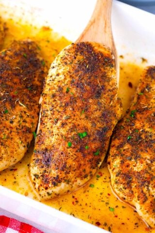 Golden brown, oven baked chicken breast on a serving spatula.