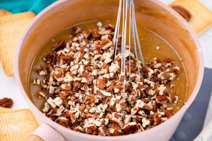 Stirring pecans into pecan pie filling mixture.