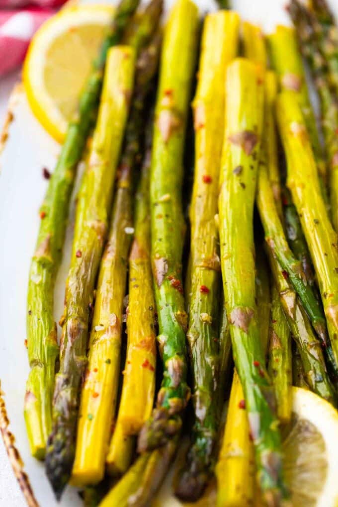 Overhead shot of oven roasted asparagus spears on a serving plate.
