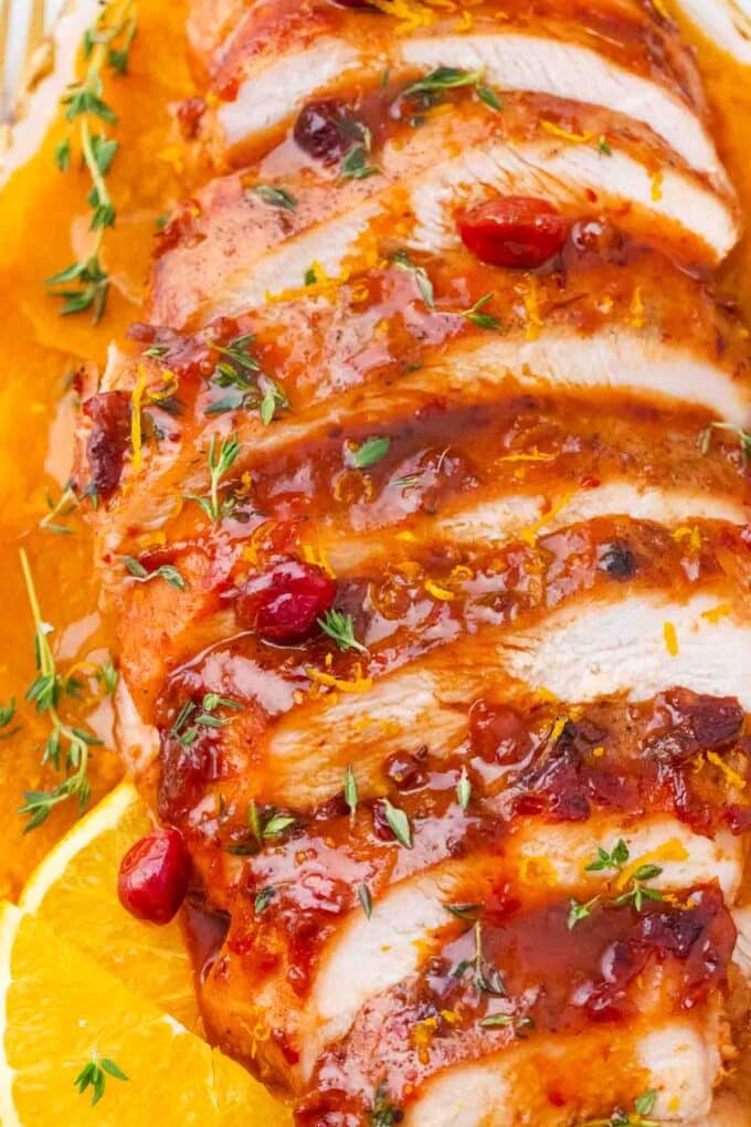 golden brown sliced roasted cranberry orange turkey breast over mashed sweet potatoes