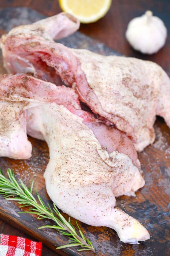 Seasoning a whole chicken.