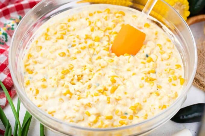 Corn casserole ingredients combined in a bowl.