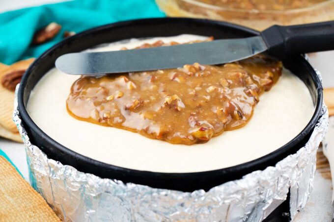Topping cheesecake with a pecan pie layer.