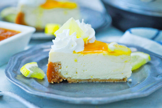 Rich and creamy slice of Instant Pot Meyer lemon cheesecake.