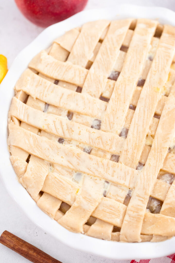 Apple pie with lattice top before baking it.