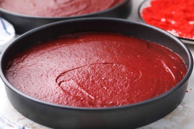 two pans with red velvet cake layer