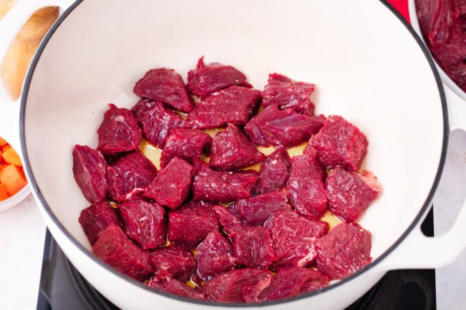 Searing beef pieces.