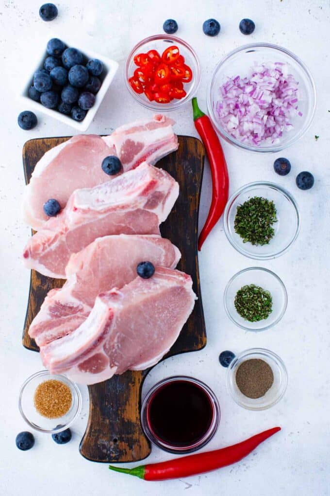 blueberry pork chops ingredients in bowls and on a cutting board