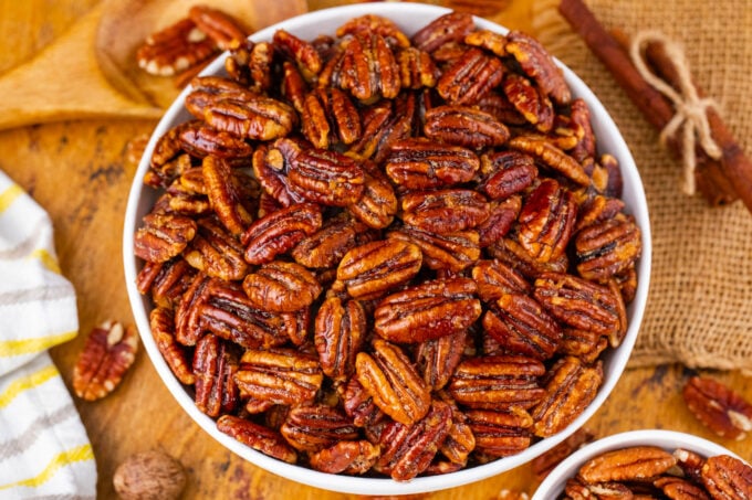 A bowl of crunchy oven roasted candied pecans.