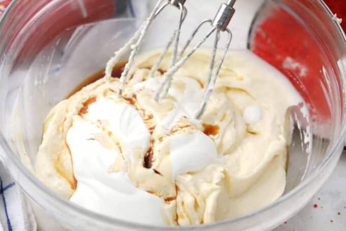 whisking cheesecake ingredients in a bowl