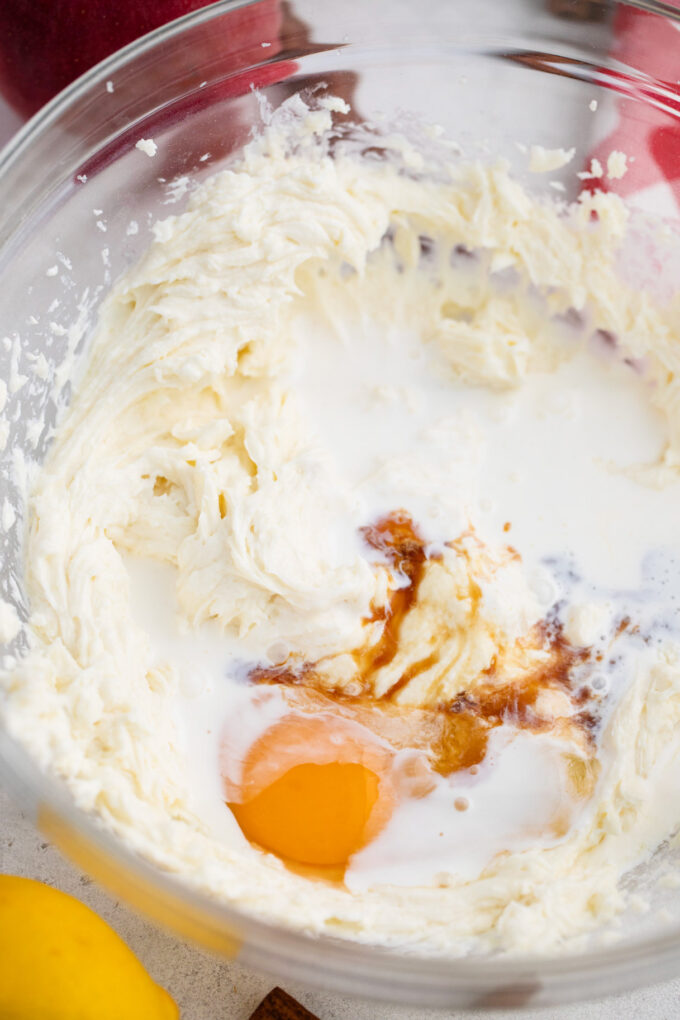 Whipping cheesecake ingredients in a bowl.