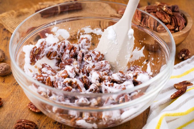 Mixing pecans with egg whites.
