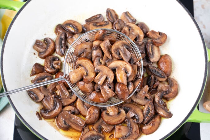 Cooked mushrooms in a cast iron pan.