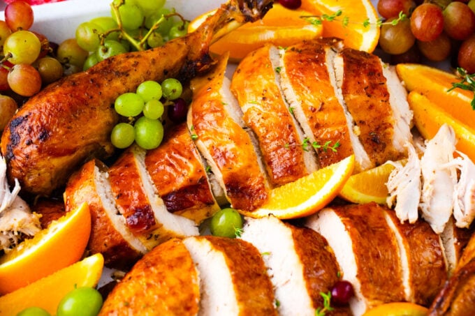 Sliced oven roasted turkey with a perfectly browned skin.