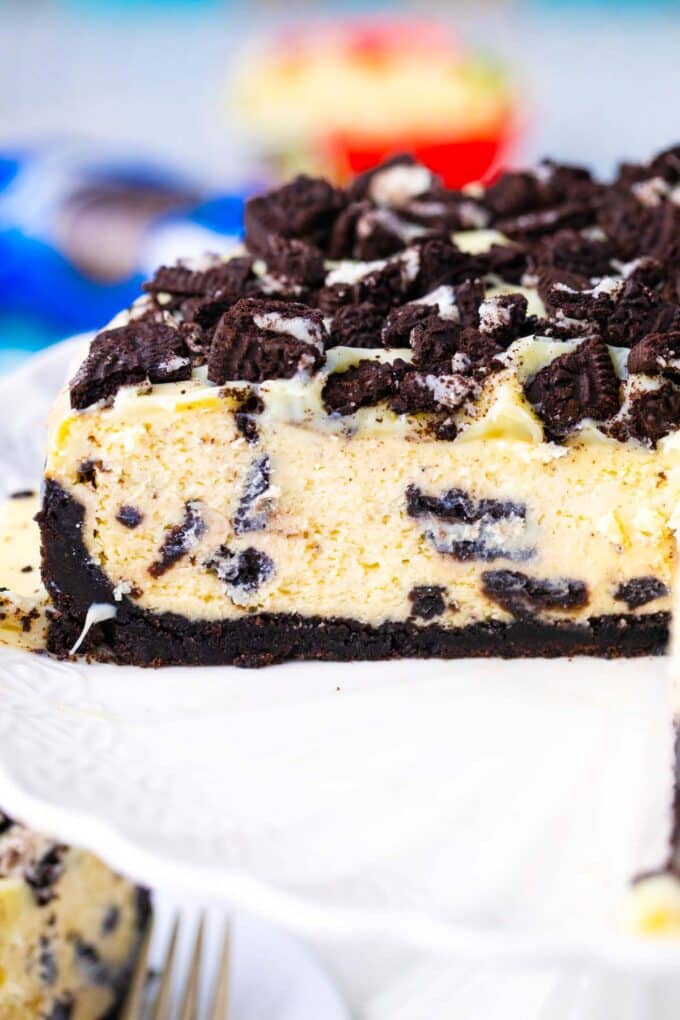 Sliced Instant Pot Oreo cheesecake on a cake stand.