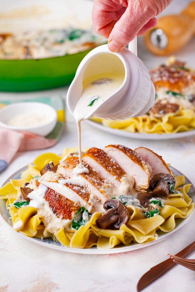 Drizzling Parmesan mushroom chicken with creamy Parmesan sauce.