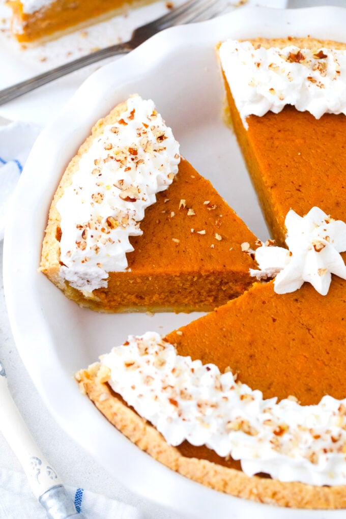 Homemade sweet potato pie slices in a pie dish.