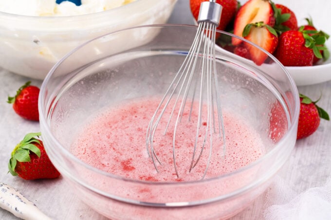Mixing gelatin into strawberry puree.