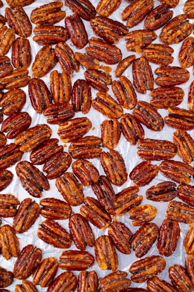 Crunchy oven roasted candied pecans on a baking sheet.