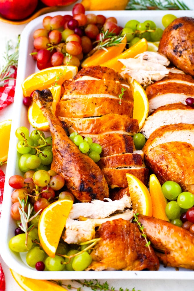 Sliced, juicy oven roasted turkey on a serving platter.