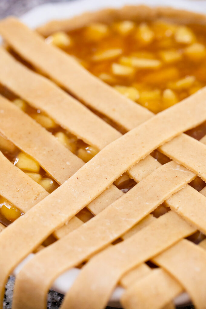 Making a lattice pie crust for apple pie.