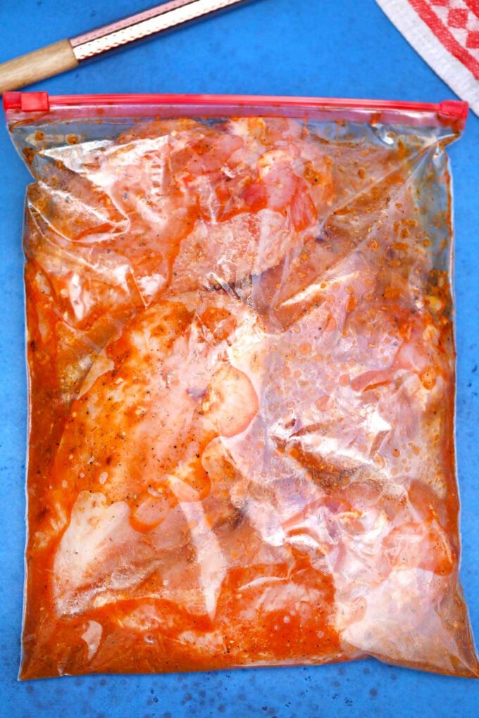 Marinating chicken in Chipotle sauce.