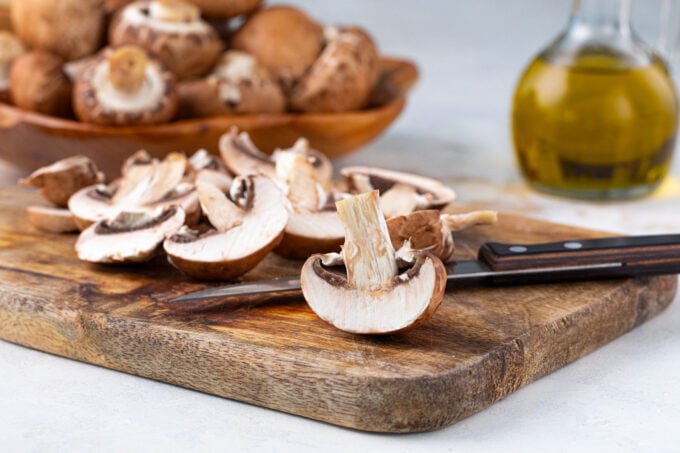Sliced mushrooms on a cutting board.