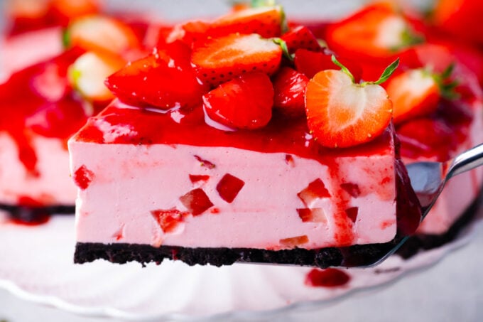 Homemade no-bake strawberry cheesecake with strawberry topping and an Oreo crust.
