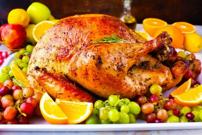 Crispy oven roasted turkey served with grapes and oranges.