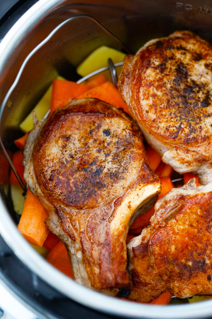 Pressure cooking pork chops with carrots and potatoes.