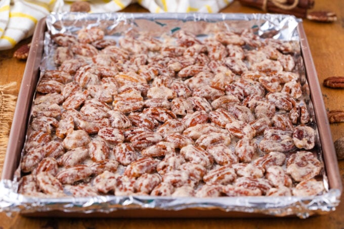 A baking sheet with pecans tossed in sugar and egg whites.