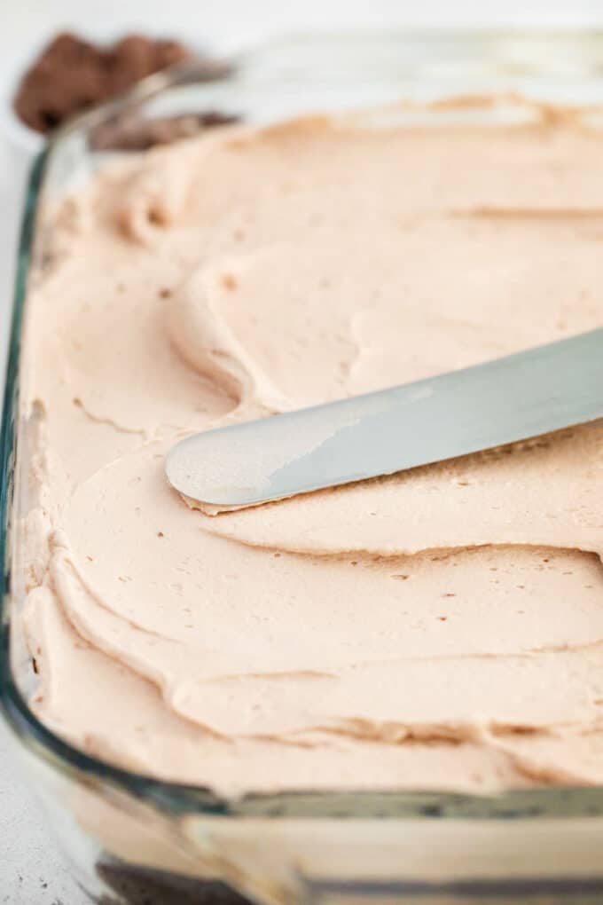 adding a layer of chocolate mousse to brownies