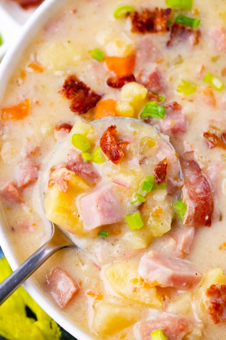 A spoonful of hearty and creamy slow cooker ham and potato soup.