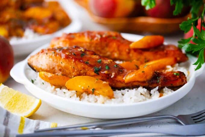 peach salmon filets on top of white rice