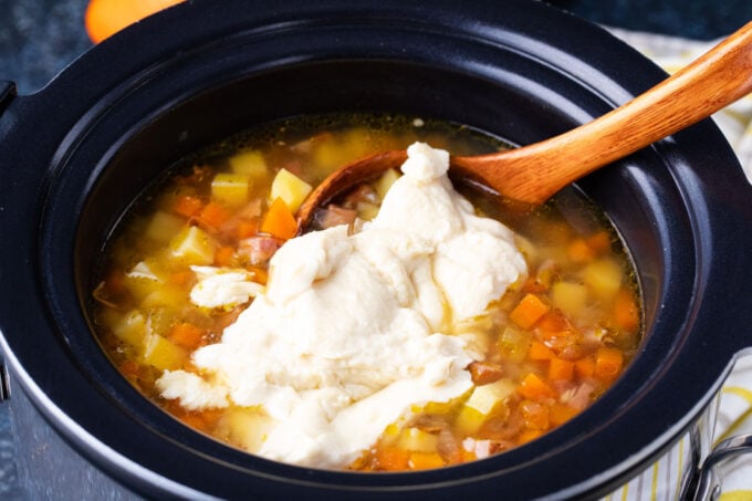 Adding a roux to slow cooker ham and potato soup.