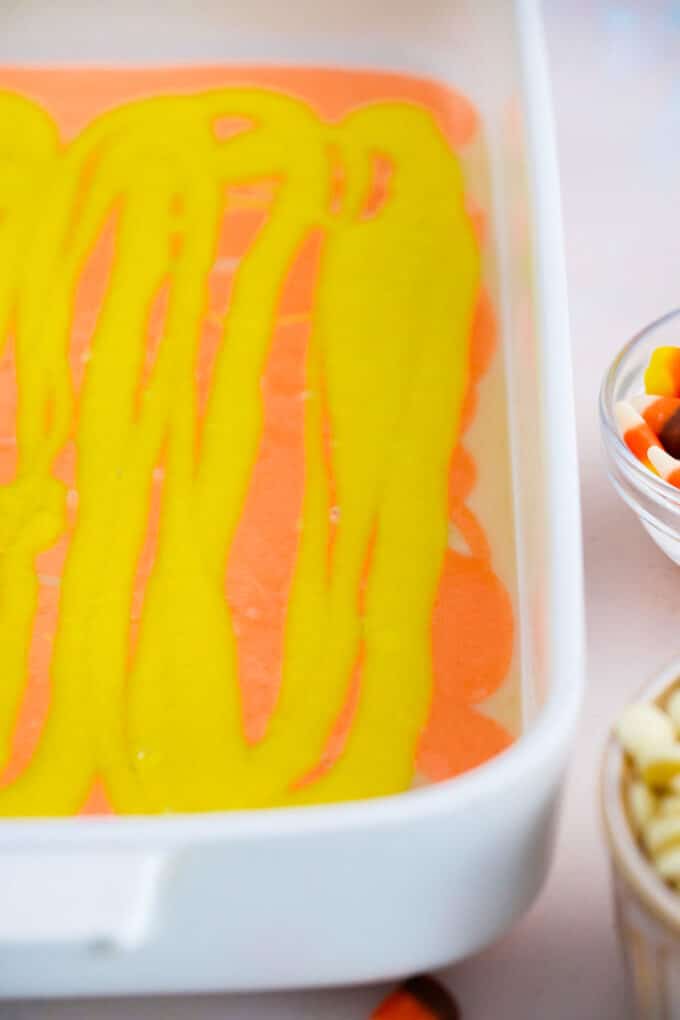 layering yellow and orange cake batter in a pan